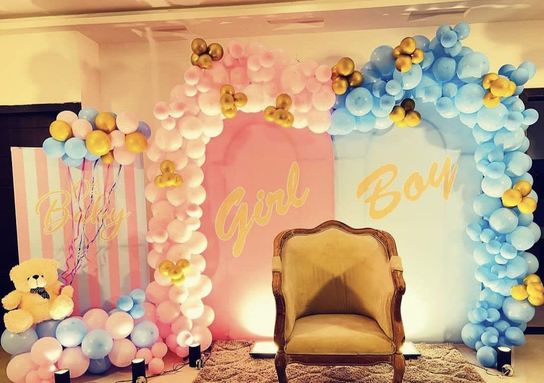 Baby shower balloon decoration with pastel arch and seating in Patna